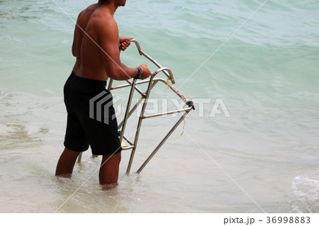 Asian strongest man with ladder for long-tail boat Asian strongest man with ladder for long-tail boat 36998883