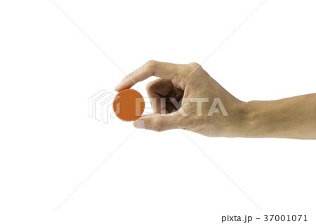 Hand holding orange bottle cap isolated on white Hand holding orange bottle cap isolated on white 37001071