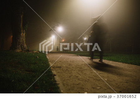 people motion blur in the park night and heavy fog 37001652