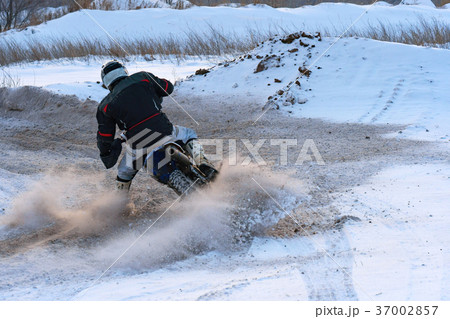 Racer man fulfills a fast ride on a motorcycle 37002857