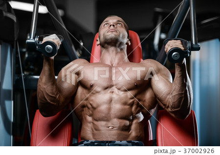 Brutal strong bodybuilder athletic men pumping up muscles with d Brutal strong bodybuilder athletic men pumping up muscles with d 37002926