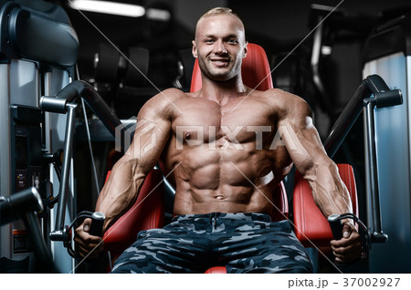Brutal strong bodybuilder athletic men pumping up muscles with d Brutal strong bodybuilder athletic men pumping up muscles with d 37002927
