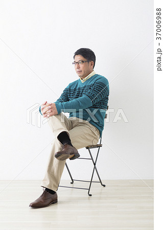 椅子に座るミドル男性の写真素材