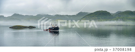 Alone boat driving through in the foggy sea in the Alone boat driving through in the foggy sea in the 37008198