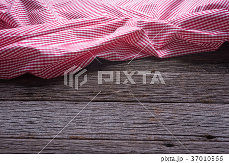red checkered tablecloth on wooden background 37010366