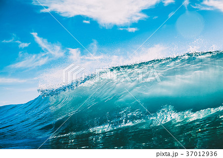 Blue barrel wave in ocean. Clear wave and sun 37012936