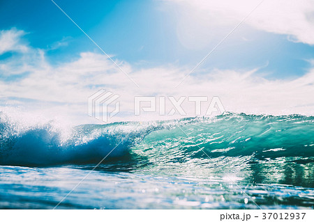 Blue wave in ocean. Glass wave and sun light 37012937