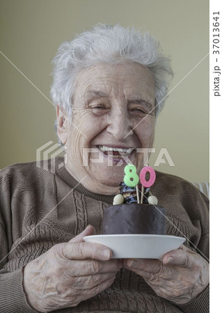 Senior woman with her birthday cake for age eighty 37013641