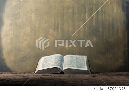 Bible and the crucifix on a old wooden oak table. 37021393