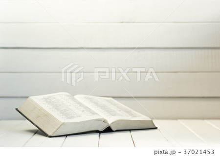 Bible and the crucifix on a white wooden table. Bible and the crucifix on a white wooden table. 37021453