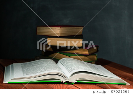 Old books on a wooden red table. 37021565