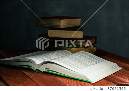 Old books on a wooden red table. 37021566