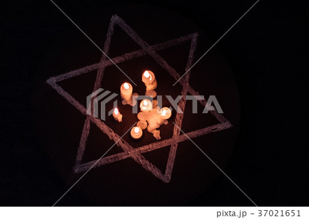 Six burning candles and the Star of David against Six burning candles and the Star of David against 37021651