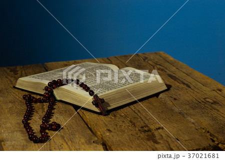 Bible and beads on a old wooden table. Bible and beads on a old wooden table. 37021681