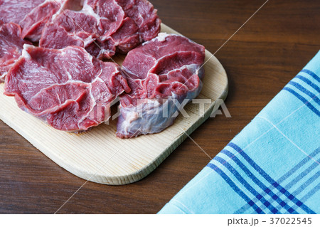 Fresh raw beef on wooden cutting plate 37022545