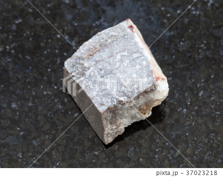 raw Rhyolite stone on dark background 37023218
