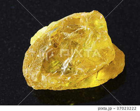 rough crystal of sulphur stone on dark background rough crystal of sulphur stone on dark background 37023222