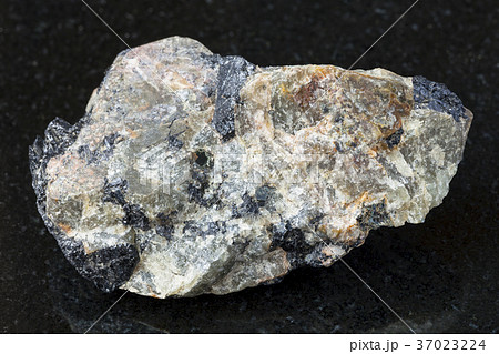 raw green Nepheline stone on dark e background 37023224