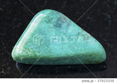 polished fuchsite (chrome mica) gemstone on dark 37023330