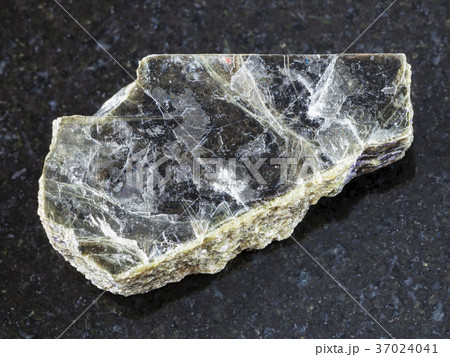 raw muscovite mica stone on dark background 37024041