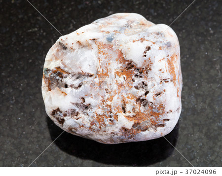 rough marble pebble on dark background 37024096