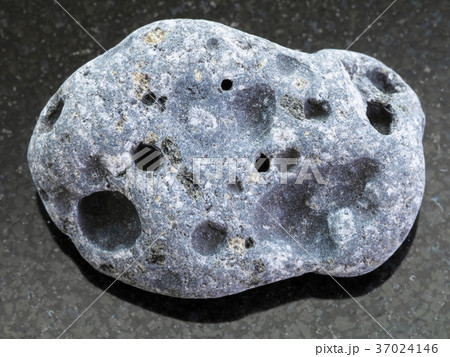 tumbled gray pumice stone on dark background 37024146