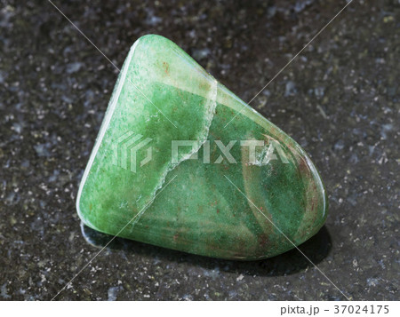 polished green aventurine gem stone on dark 37024175