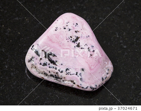 raw rhodochrosite gem on dark background 37024671