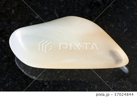 polished yellow moonstone (adularia) gem on dark 37024844