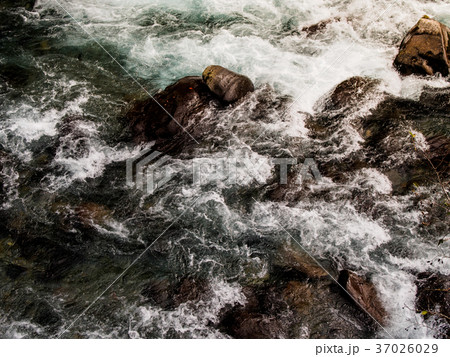 The river flows through the rocks. 37026029