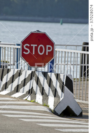 road sign stop in port near sea 37028074