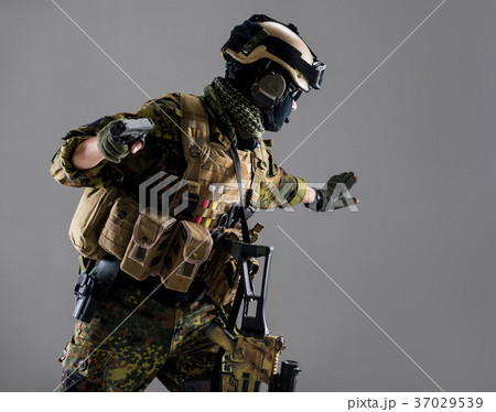 Serious man keeping weapon in hands Serious man keeping weapon in hands 37029539