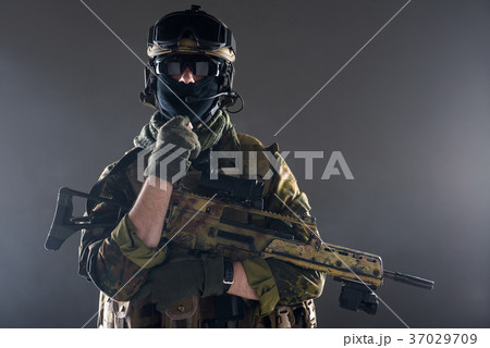 Calm man in ammunition holding weapon Calm man in ammunition holding weapon 37029709