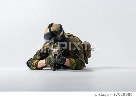 Soldier looking at sniper scope of rifle 37029980