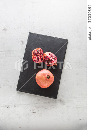 Pomegranate. Pieces of frest pomegranate on plate 37030394
