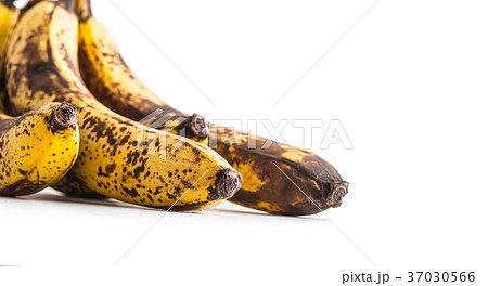 Over ripe bananas isolated on white with shadows. Over ripe bananas isolated on white with shadows. 37030566