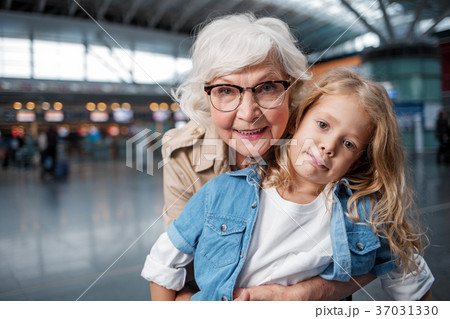 Optimistic elderly lady is posing at terminal with 37031330
