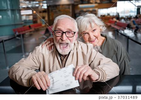 Happy elderly couple are demonstrating their 37031489