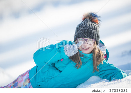 Happy young Pre-Teen girl in warm clothingin snow. Happy young Pre-Teen girl in warm clothingin snow. 37033081
