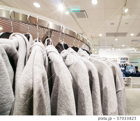Gray sweatshirts in shopping store, copy space Gray sweatshirts in shopping store, copy space 37033825