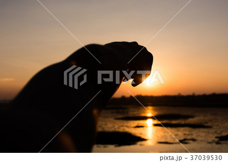 Silhouette of hand the boy and sunset background. Silhouette of hand the boy and sunset background. 37039530