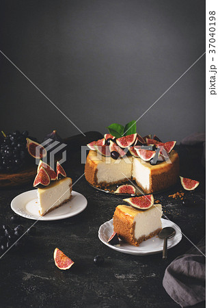 Sliced New York Cheesecake on dark stone 37040198