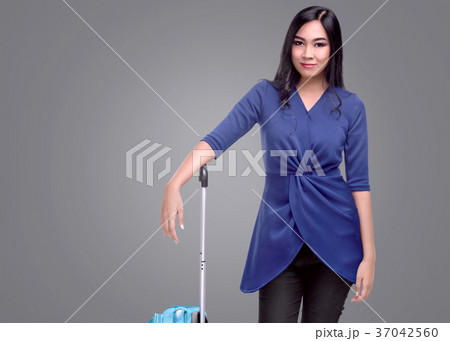 Pretty asian tourist woman with a suitcase Pretty asian tourist woman with a suitcase 37042560