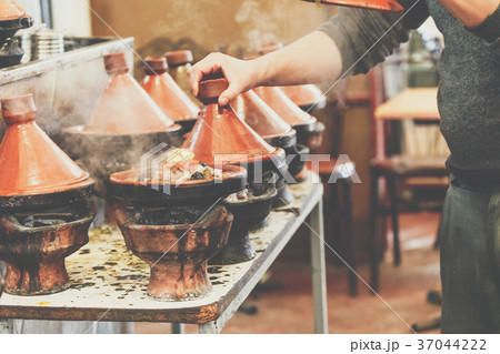 Cooking of meat in traditional Moroccan tajine Cooking of meat in traditional Moroccan tajine 37044222
