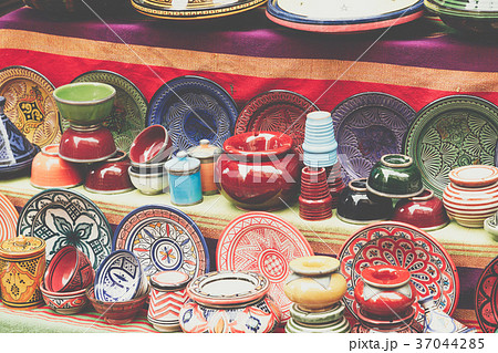 Plates, tajines and pots made of clay on the souk Plates, tajines and pots made of clay on the souk 37044285