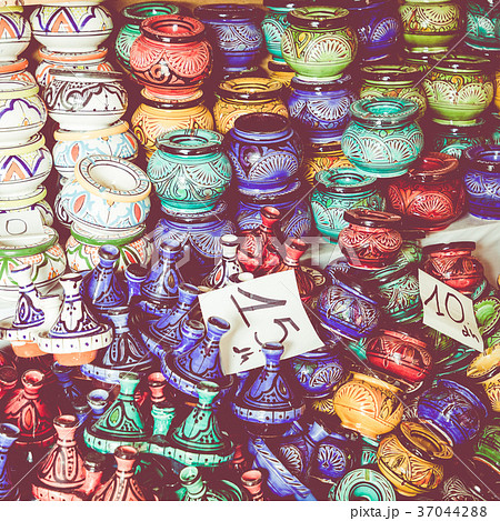 Plates, tajines and pots made of clay on the souk Plates, tajines and pots made of clay on the souk 37044288