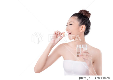 Woman taking medicine over white background 37044620