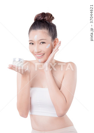 woman with cream on face smiling over white woman with cream on face smiling over white 37044621