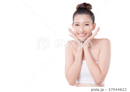 woman with cream on face smiling over white woman with cream on face smiling over white 37044622