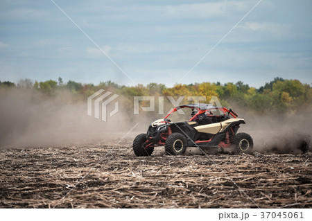 Quad bike in a plowed field Quad bike in a plowed field 37045061